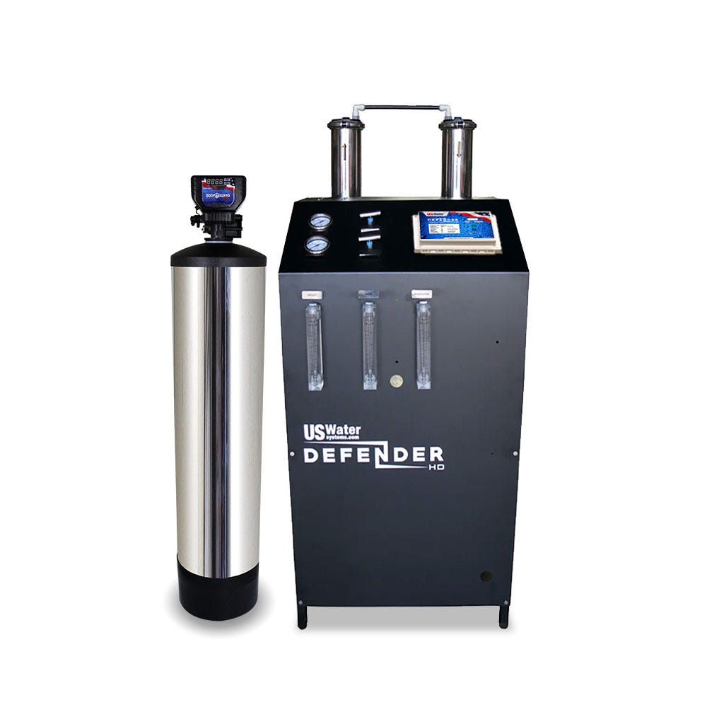 The eco-friendly Defender Commercial RO System by US Water Systems features a tall cylindrical tank left of a sleek black rectangular unit labeled Defender, equipped with gauges, pipes, and a digital control panel—ideal for any commercial use.