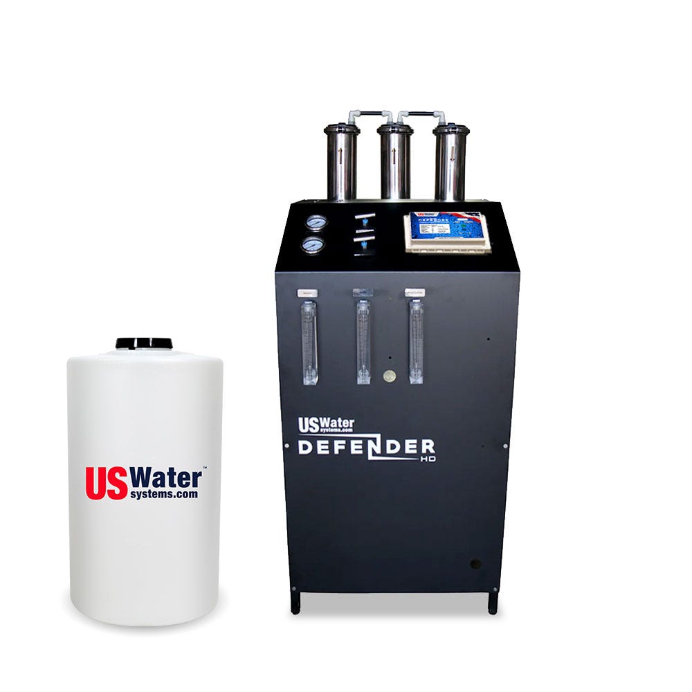 The eco-friendly Defender Commercial RO System by US Water Systems Inc., offering 2000-16000 GPD, boasts three vertical filters and a control panel beside a branded white cylindrical tank, showcasing sustainable commercial water filtration.