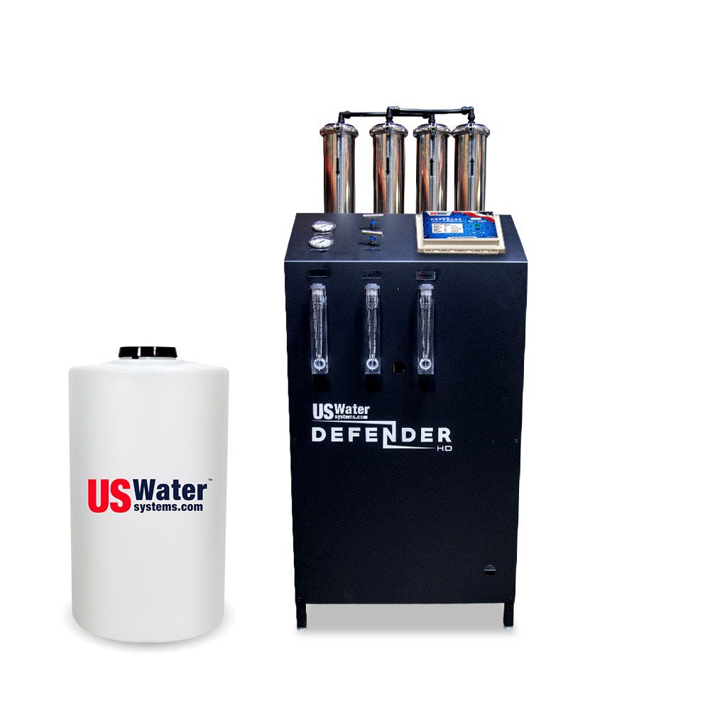 The Defender Commercial RO System by US Water Systems Inc, featuring a black box labeled US Water Defender with four cylinders and a white tank with the USWaterSystems.com logo, is an eco-friendly choice for any Commercial RO System setup.