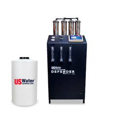 The Defender Commercial RO System by US Water Systems Inc, featuring a black box labeled US Water Defender with four cylinders and a white tank with the USWaterSystems.com logo, is an eco-friendly choice for any Commercial RO System setup.