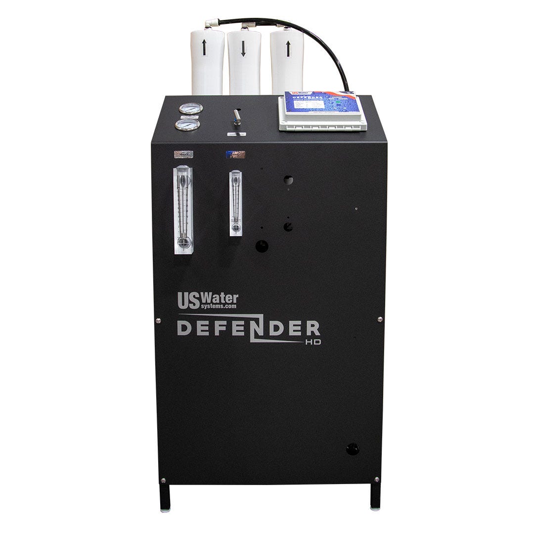 The DEFENDER Commercial Brackish Water RO System by US Water Systems Inc (4,000–8,000 GPD) features gauges, flow meters, and a control panel on the front; made in the USA and built for heavy-duty commercial use.
