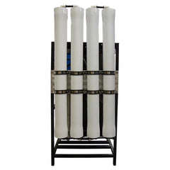 The DEFENDER Commercial Brackish Water RO System by US Water Systems Inc features four vertical white filters on a black metal frame, delivers 4,000-8,000 GPD, and is made in the USA.