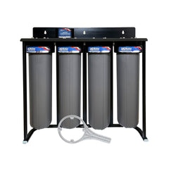 The US Water Systems Zeta-Charged 4-Stage Filter System by US Water Systems Inc features large gray housings on a black metal frame and includes a Zeta-Charged filter; a white filter wrench is shown in front.