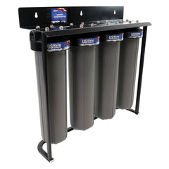 The US Water Systems Inc Zeta-Charged 4-Stage Filter System features vertical cylindrical housings on a black metal frame.