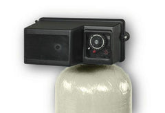 The Fleck 3150 2 Backwashing Catalytic Carbon Filter by US Water Systems Inc features a control valve atop its cylindrical tank with a dial and buttons, efficiently removing iron and sulfur to enhance water quality.