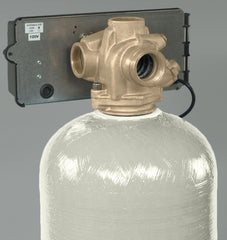 A close-up view of the Fleck 3150 2 Backwashing Catalytic Carbon Filter by US Water Systems Inc, featuring a control valve on a translucent fiberglass tank, expertly designed for iron and sulfur removal.