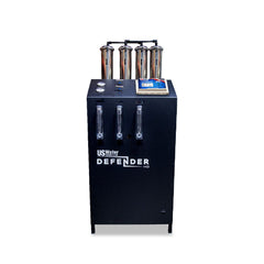 The Defender Commercial RO System by US Water Systems Inc, featuring gauges, labels, four vertical cylinders, and a control panel on top, provides an eco-friendly solution for your water filtration needs.