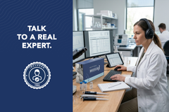 A female scientist wearing headphones works at a computer in a lab; text on the left reads: Talk to a real US Water Systems Inc expert about your Waterlogix Premium Water Test—free consultation included.