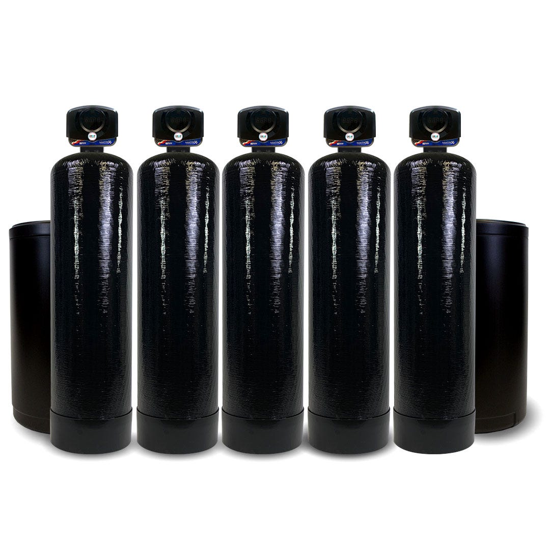 Five tall, black Matrixx-Drop 1.25" Wifi Enabled Water Softeners by US Water Systems Inc are lined up in a row, showcasing a commercial water softening system against a plain white background.
